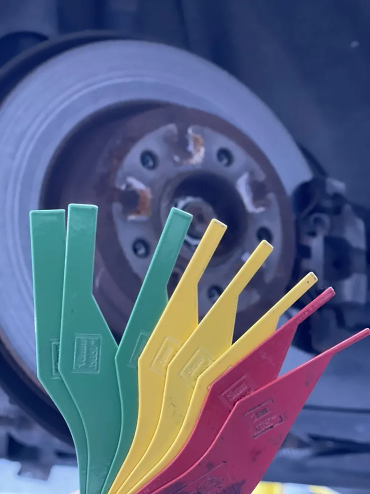 Colour-coded gauges used to measure remaining brake pad thickness