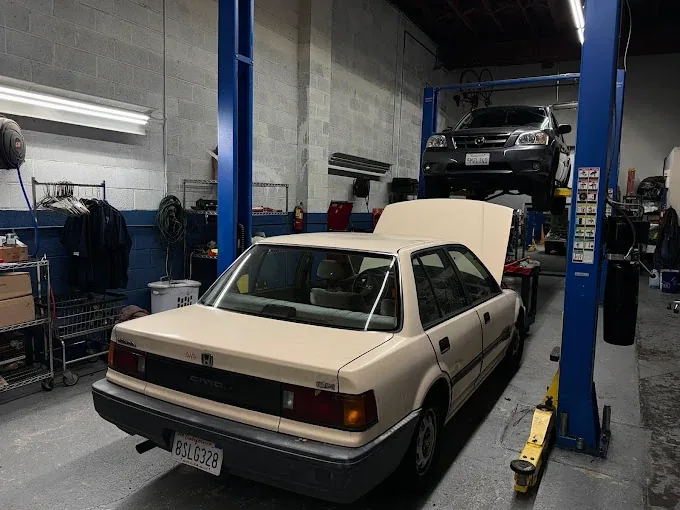 A vehicle up on the lift inside the T-21 service bay